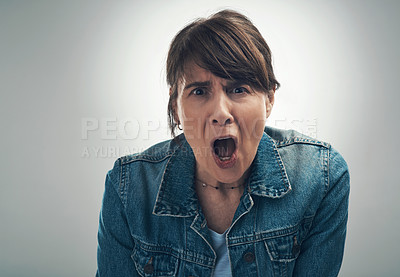 Buy stock photo Studio portrait of a senior woman yelling against a grey background