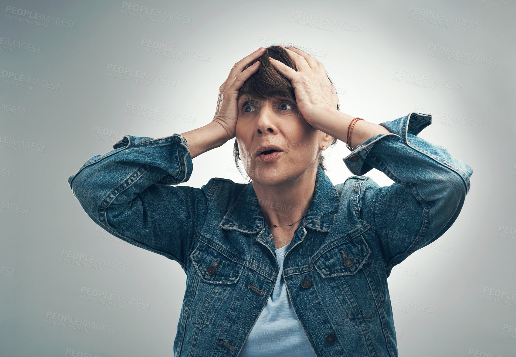 Buy stock photo Studio shot of a senior woman looking worried against a grey background