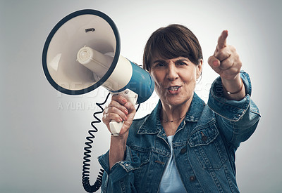 Buy stock photo Studio portrait of a senior woman using a megaphone against a grey background
