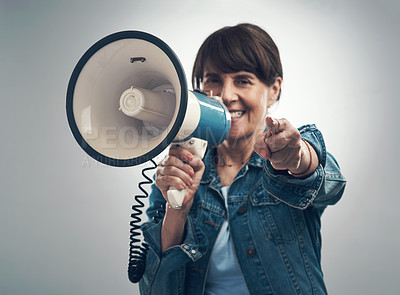 Buy stock photo Studio portrait of a senior woman using a megaphone against a grey background