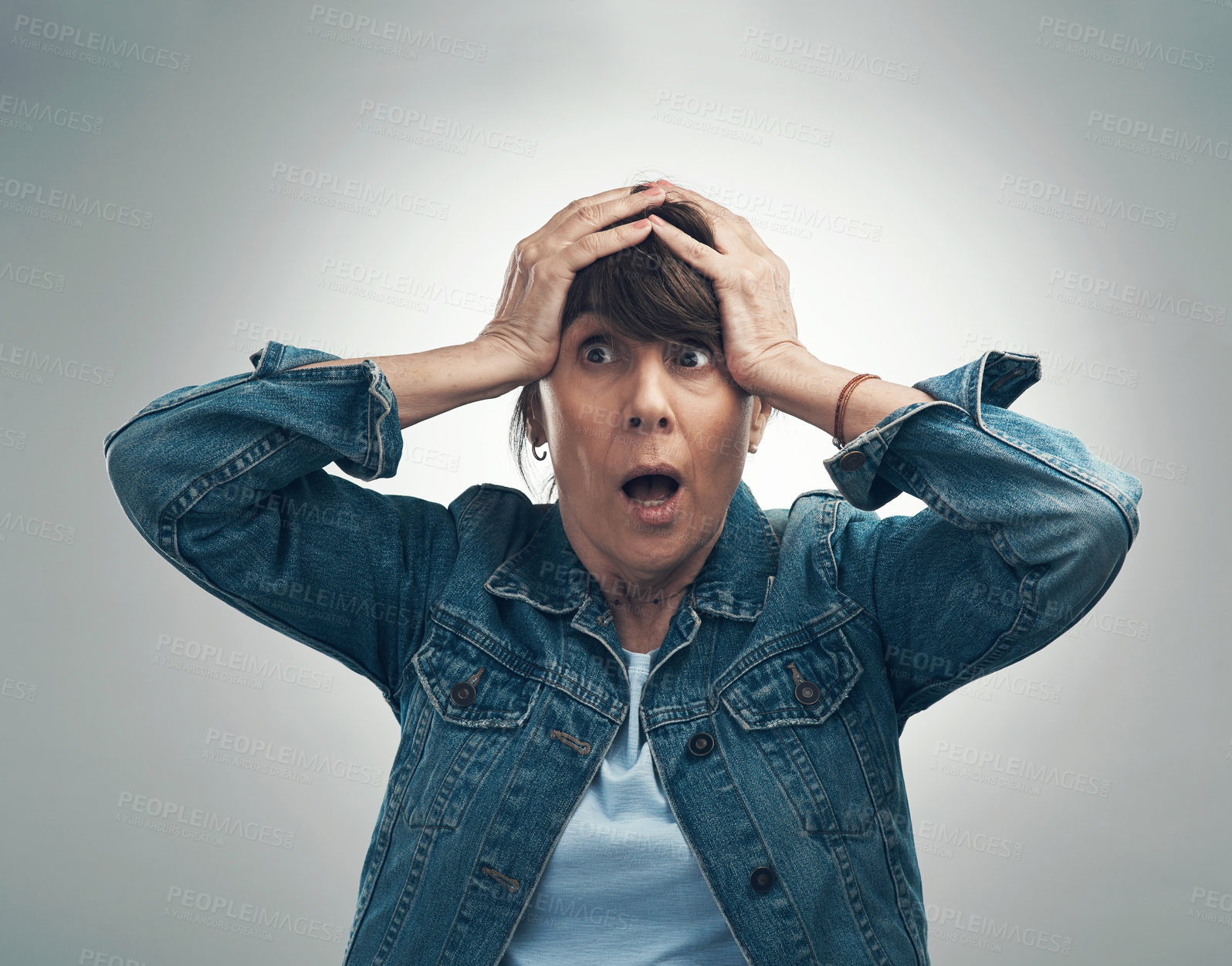 Buy stock photo Studio shot of a senior woman looking shocked against a grey background