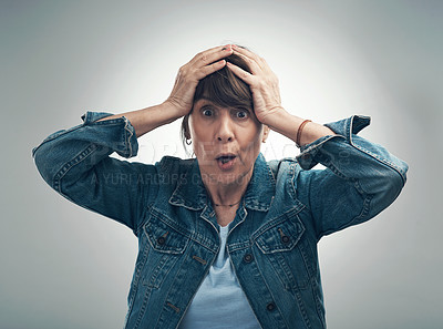 Buy stock photo Studio portrait of a senior woman looking shocked against a grey background