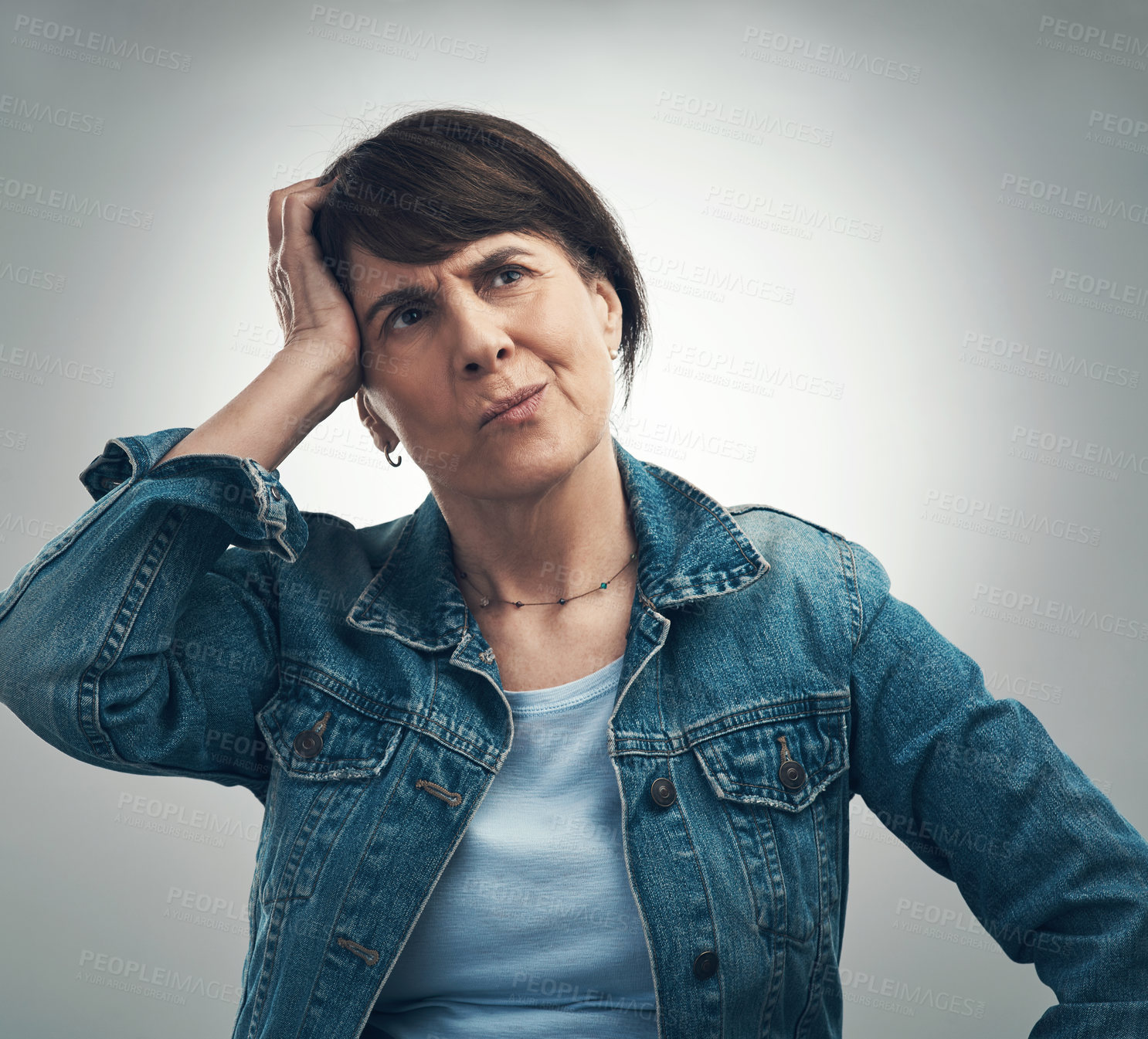Buy stock photo Studio shot of a senior woman scratching her head in confusion against a grey background