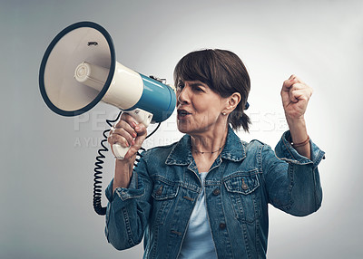 Buy stock photo Studio shot of a senior woman using a megaphone against a grey background