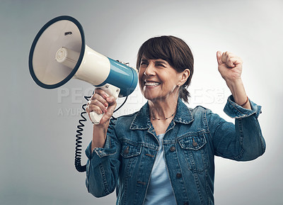 Buy stock photo Studio shot of a senior woman using a megaphone against a grey background