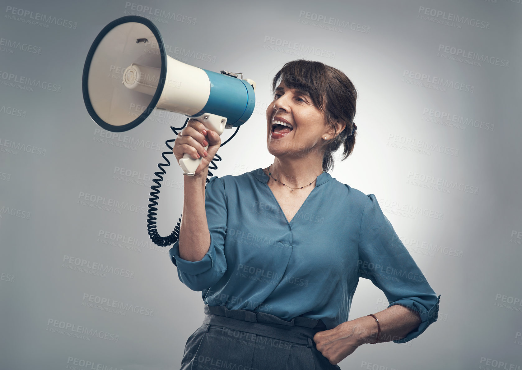 Buy stock photo Studio shot of a senior woman using a megaphone against a grey background