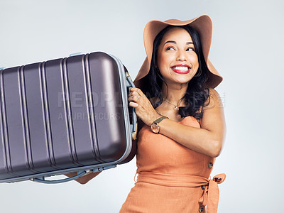 Buy stock photo Studio shot of a beautiful young woman holding up her suitcase while standing against a white background
