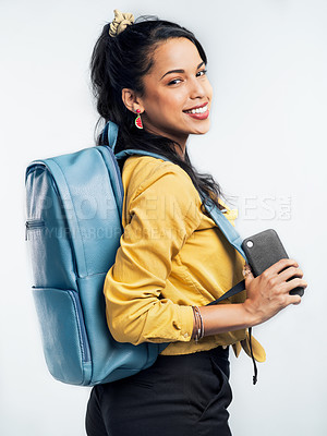 Buy stock photo Studio shot of a young woman wearing a backpack while standing against a white background