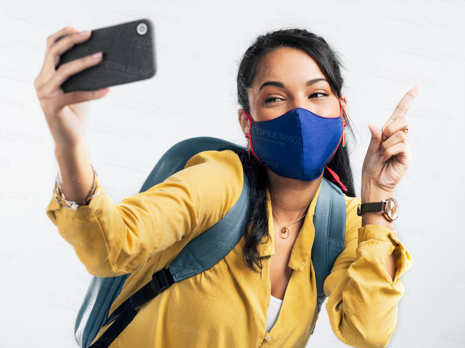 Buy stock photo Shot of a young woman taking a selfie while wearing a mask against a white background