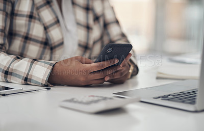 Buy stock photo Cropped shot of an unrecognizable businesswoman sitting alone in her office and using her cellphone