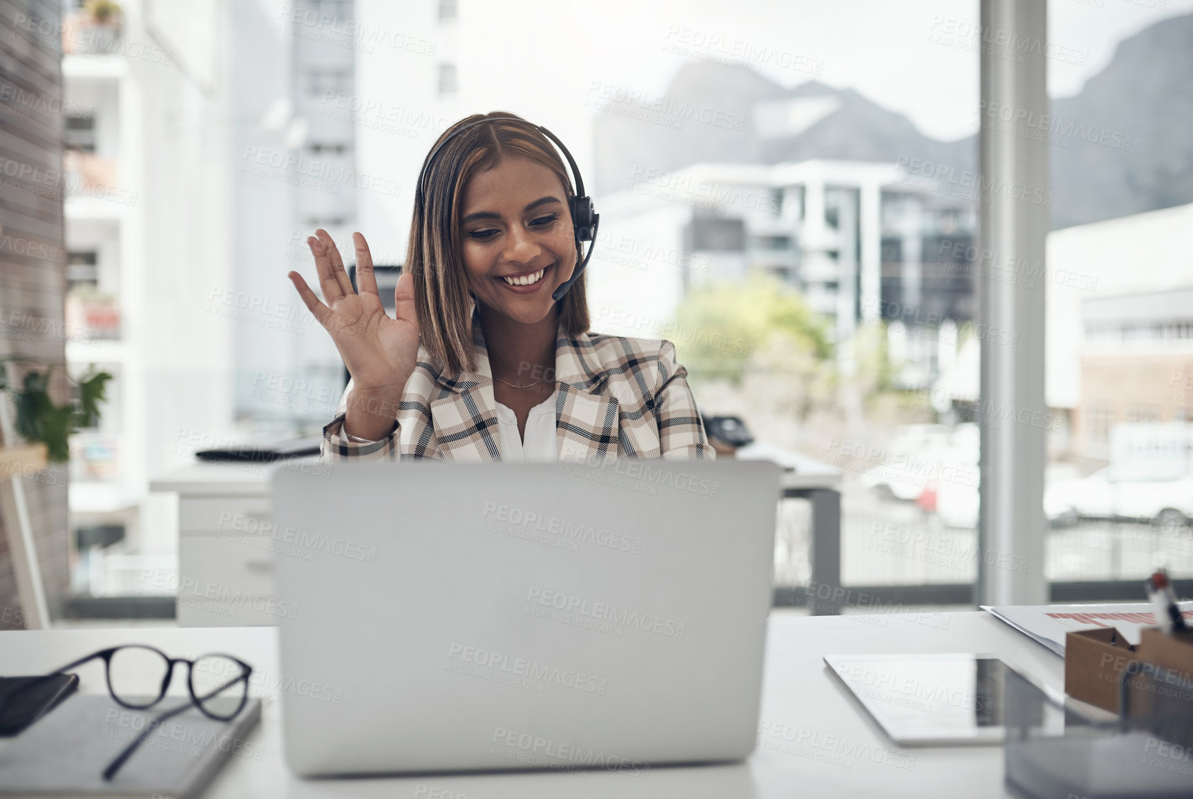 Buy stock photo Business woman, headset and laptop for a video call and hand to wave hello on webinar with internet. Female person with technology for communication, online meeting and customer support in an office