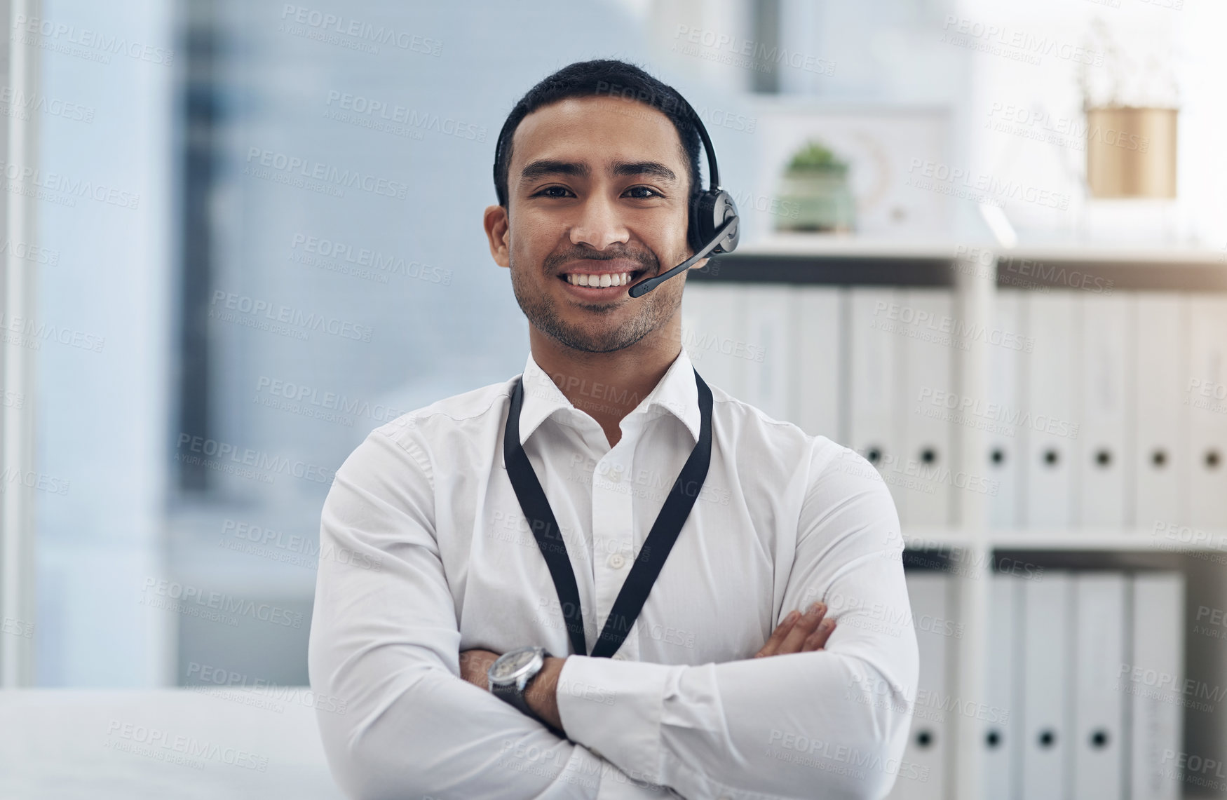 Buy stock photo Smile, headset and a man in a call center for customer service, telemarketing or help desk. Asian male person with arms crossed for contact us, telecom support or crm consultant or agent at a company