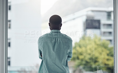 Buy stock photo Back, thinking and window with a business black man standing in his office looking at a city view. Idea, motivation and inspiration with a male employee at work, contemplating a decision in town
