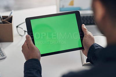 Buy stock photo Cropped shot of an unrecognizable businessman sitting alone in his office and using a digital tablet