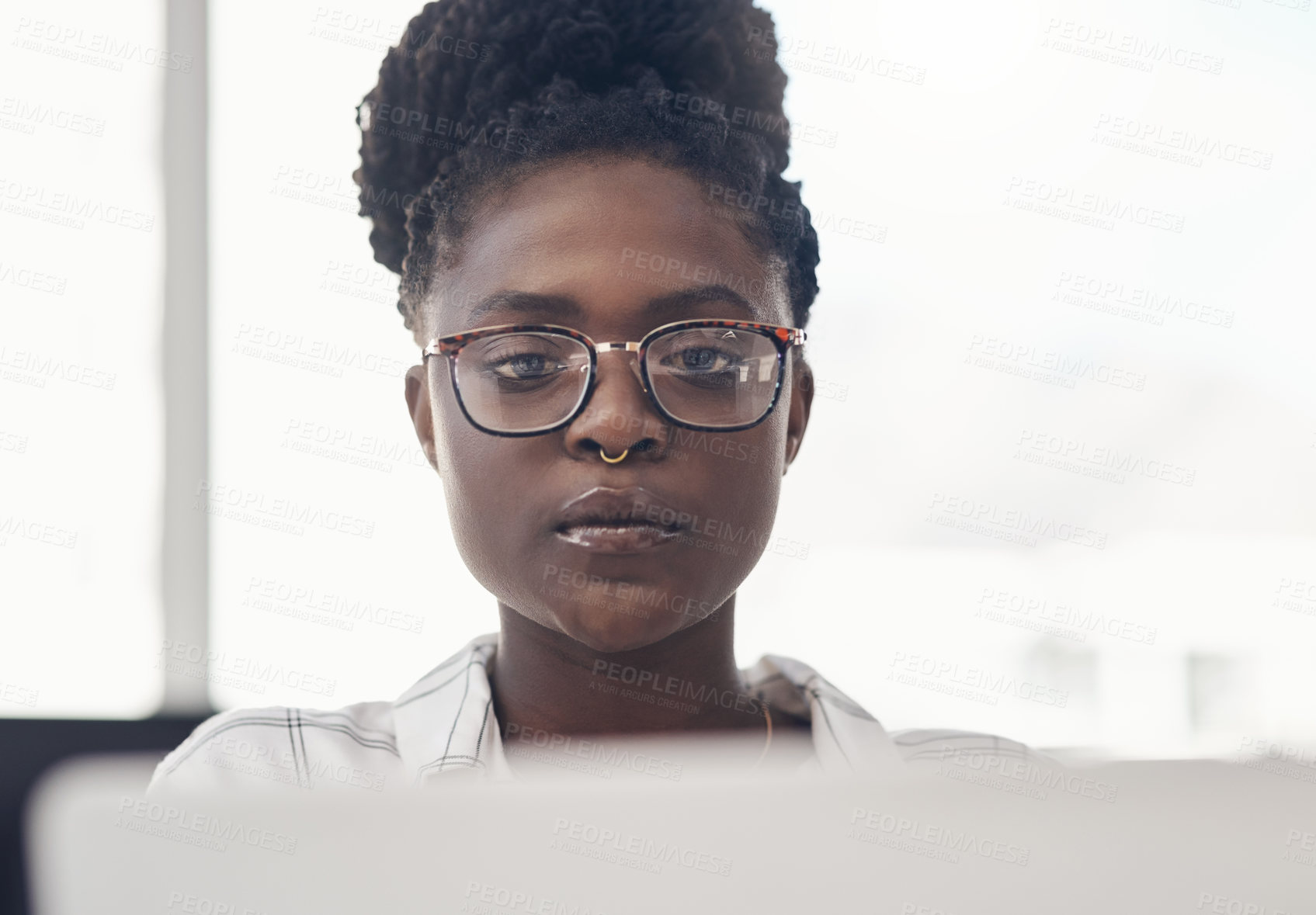 Buy stock photo Black woman, entrepreneur and focus on computer at the office for online search for business. Professional female, tech and working with serious face for a project on the internet for a start up.