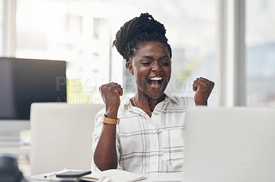 Buy stock photo Shot of an attractive young businesswoman sitting alone in her office and celebrating an achievement while using her laptop