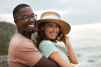 Buy stock photo Shot of a happy young couple enjoying a romantic vacation along the coast