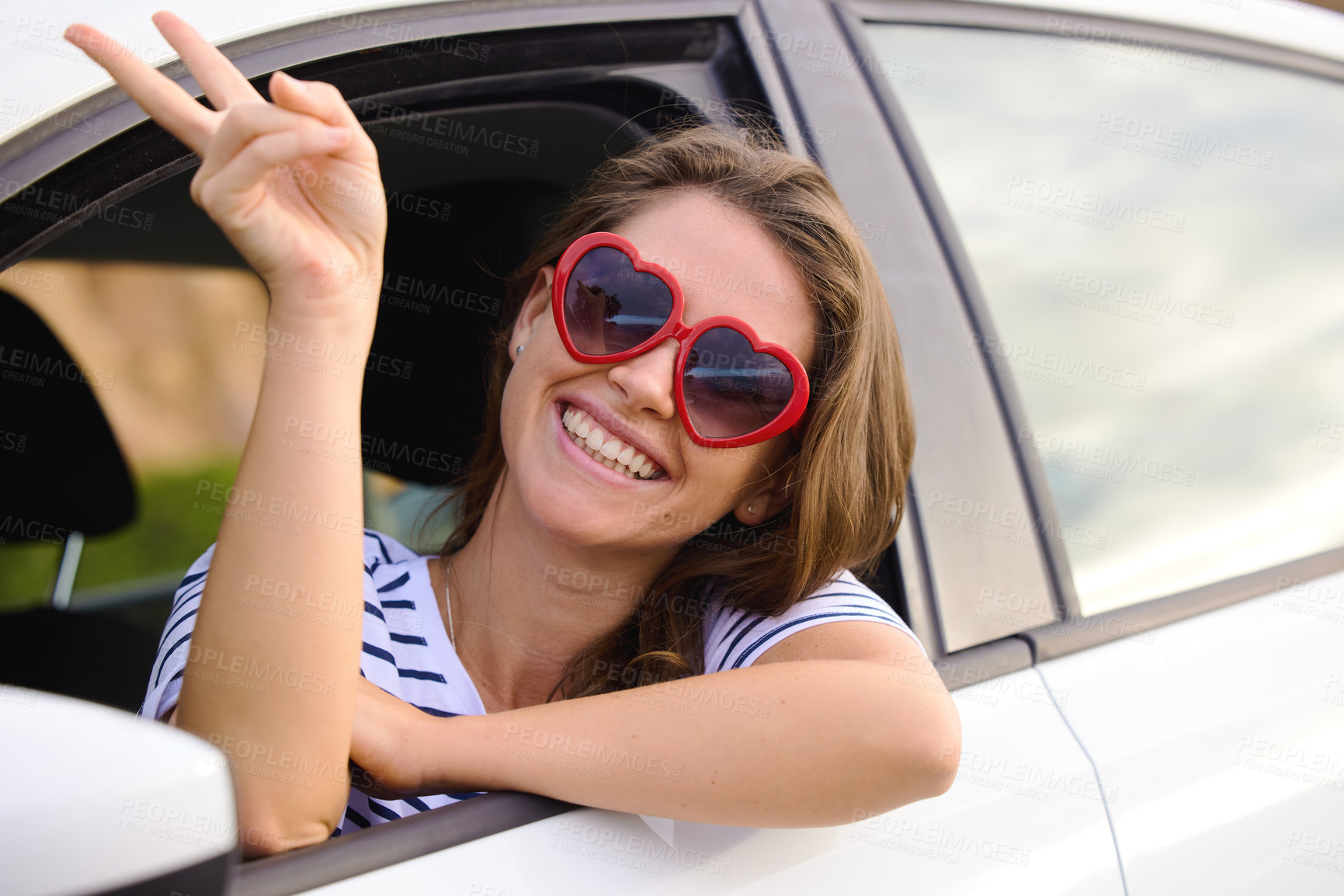 Buy stock photo Happy woman, peace sign and portrait in car for travel, adventure or road trip in city for summer vacation. Person, smile and heart glasses with gesture for emoji, comic and crazy in transportation
