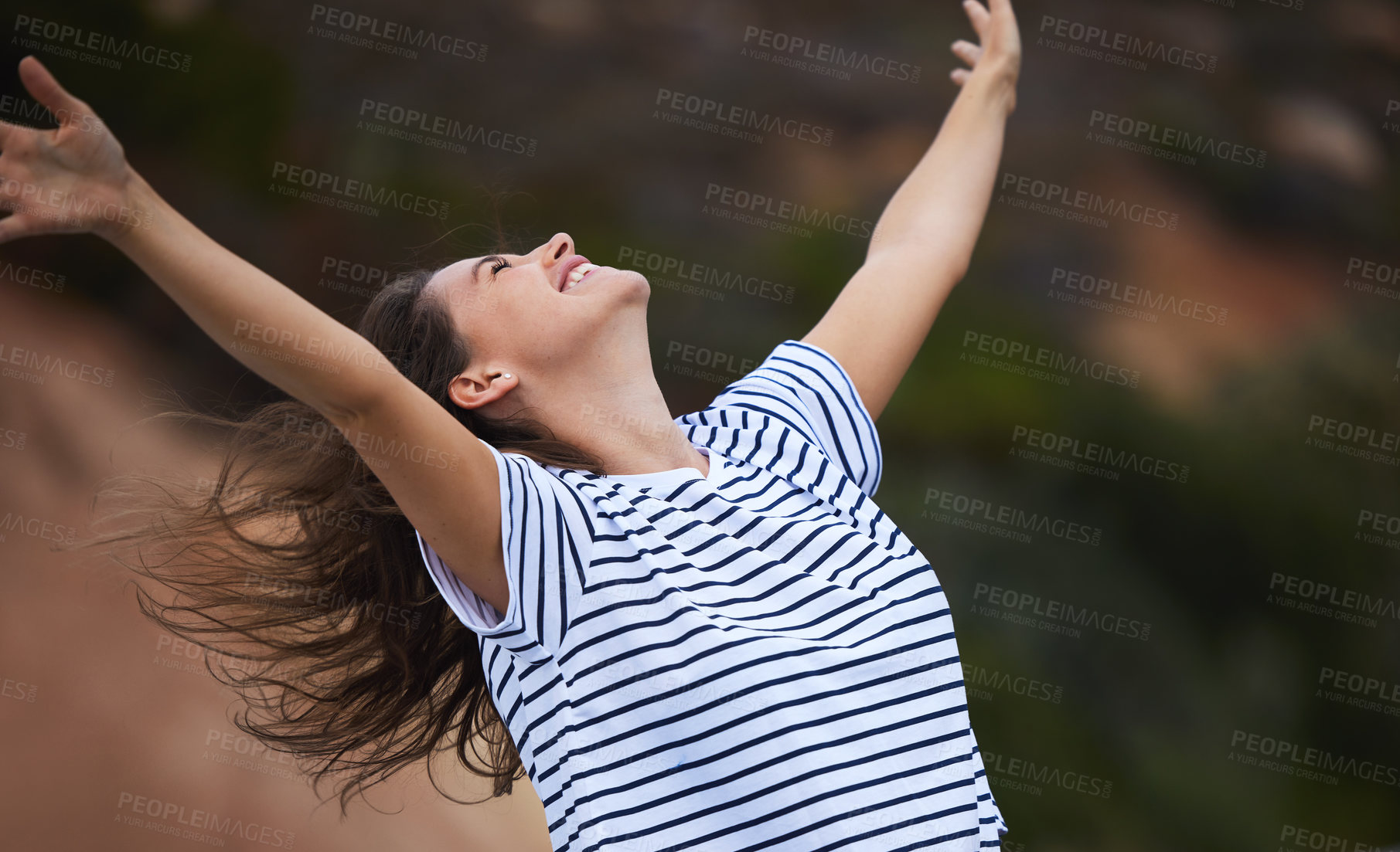 Buy stock photo Shot of a young woman celebrating while out in nature