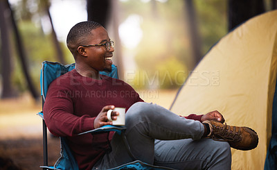 Buy stock photo Shot of a man drinking coffee while sitting on a camping chair outside