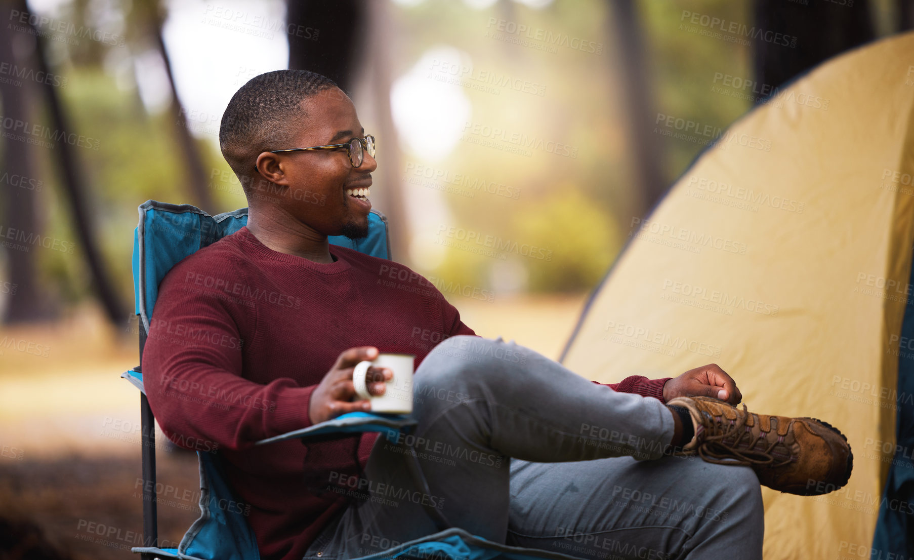 Buy stock photo Shot of a man drinking coffee while sitting on a camping chair outside