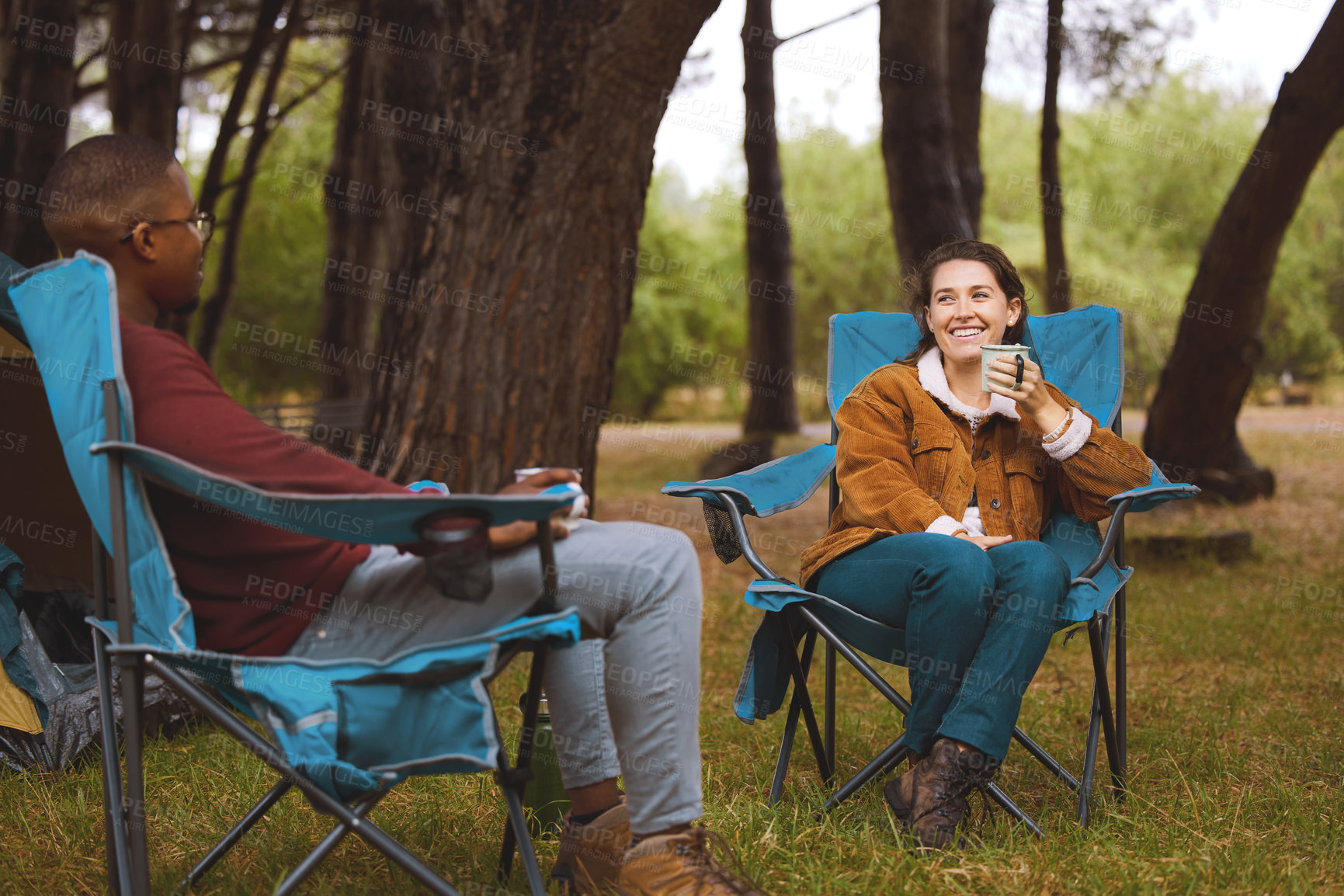 Buy stock photo Camping, man and woman relax in chair with morning drink, chat or happy vacation with outdoor adventure. Forest, nature and couple bonding together on holiday with coffee, tent and getaway in woods
