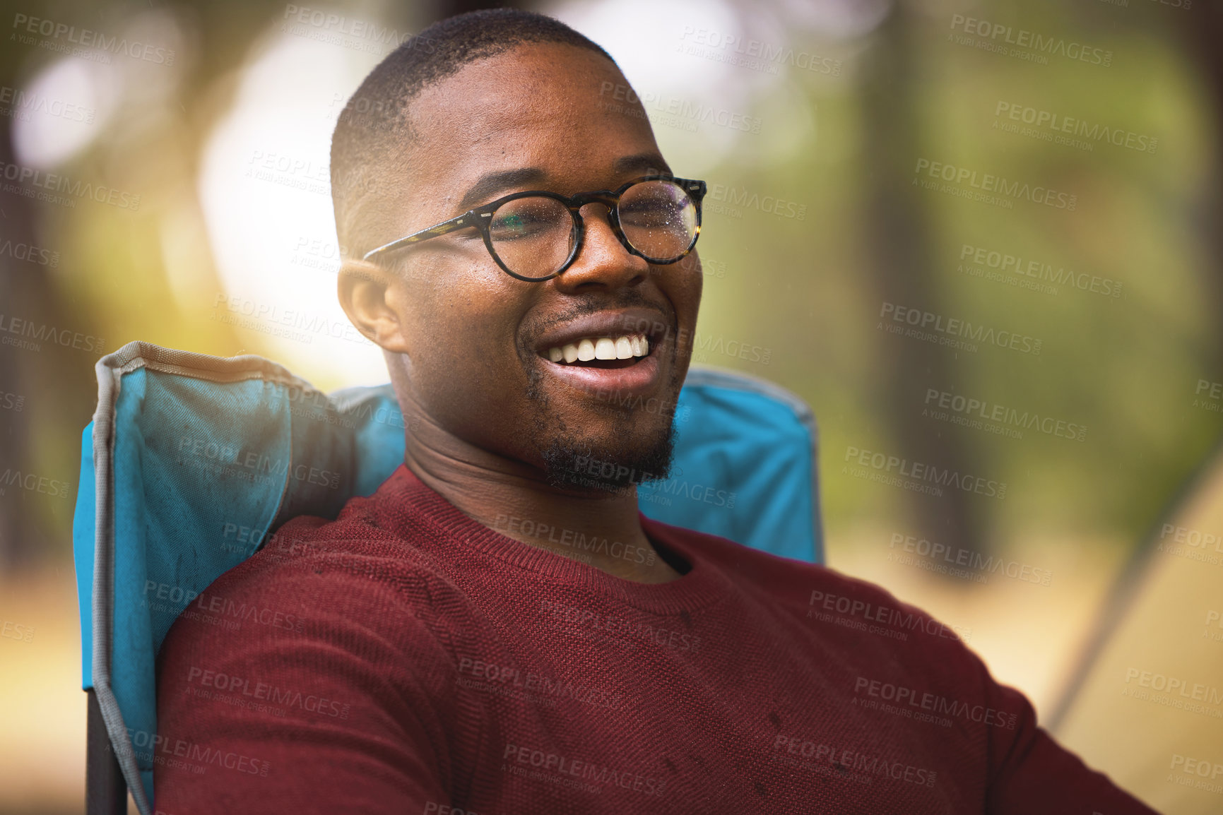 Buy stock photo Camping, portrait and black man relax outdoor on vacation in wilderness for peace and wellness in Norway. Person, happy and chair in forest woods for adventure in nature, summer holiday and fresh air