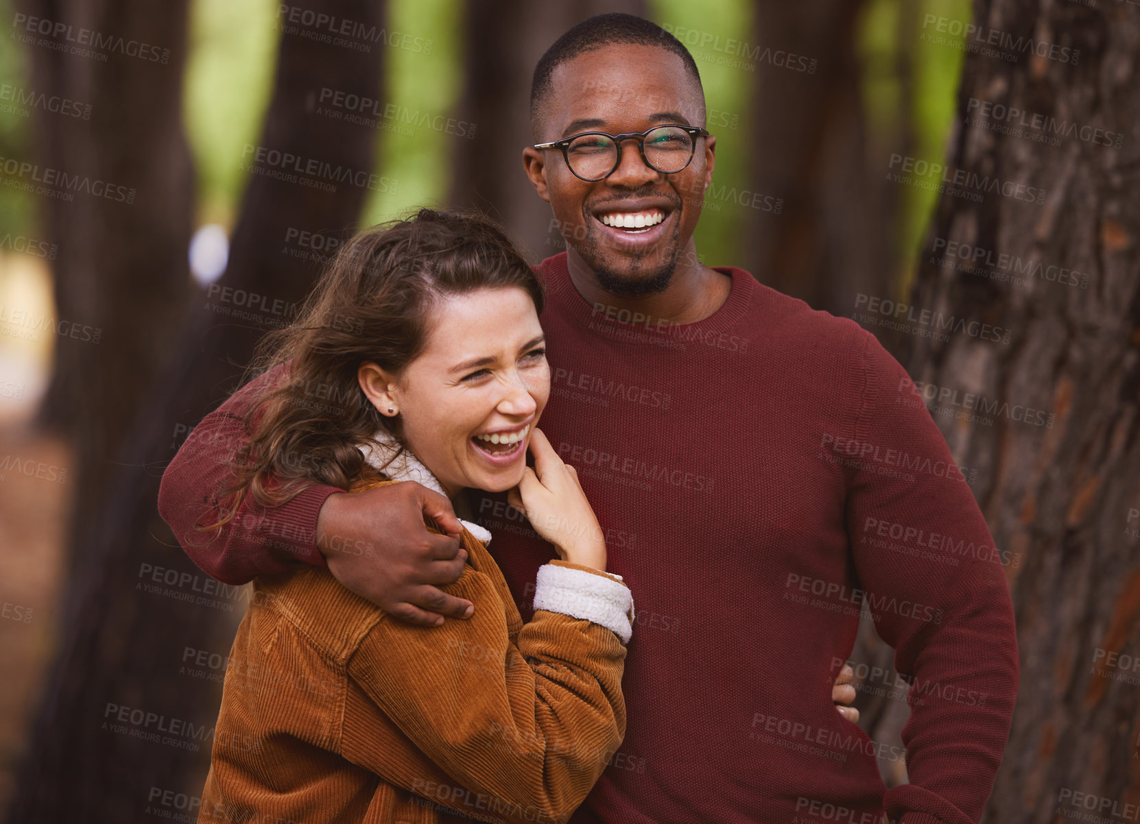 Buy stock photo Love, happiness and portrait of couple in outdoor for camping in wilderness on anniversary date in Norway, countryside. Interracial people, travel and hug on holiday in forest for peace and adventure