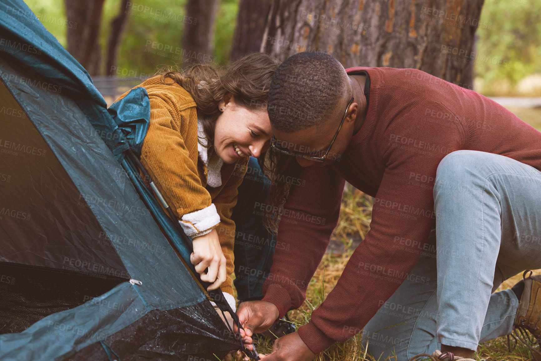 Buy stock photo Couple, camping and setting tent in outdoors in forest with teamwork, cooperation and bonding for adventure. Active, woman and man on vacation by hiking for fitness or wilderness experience in woods