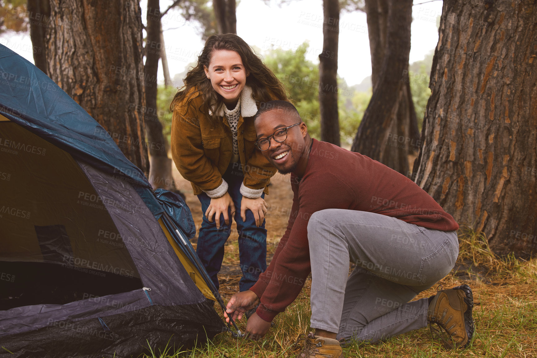 Buy stock photo Woods, camping and portrait of couple with tent in outdoor countryside in Norway for adventure date. Interracial people, love and travel with shelter for wilderness on holiday or vacation in nature.