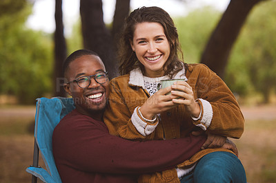 Buy stock photo Couple, chair and love with camping in woods for weekend, fun adventure and interracial. Happy man, woman and sitting in forest for happiness with green trees, nature holiday and coffee with mug