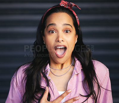 Buy stock photo Cropped portrait of an attractive young woman looking surprised while posing against a grey background