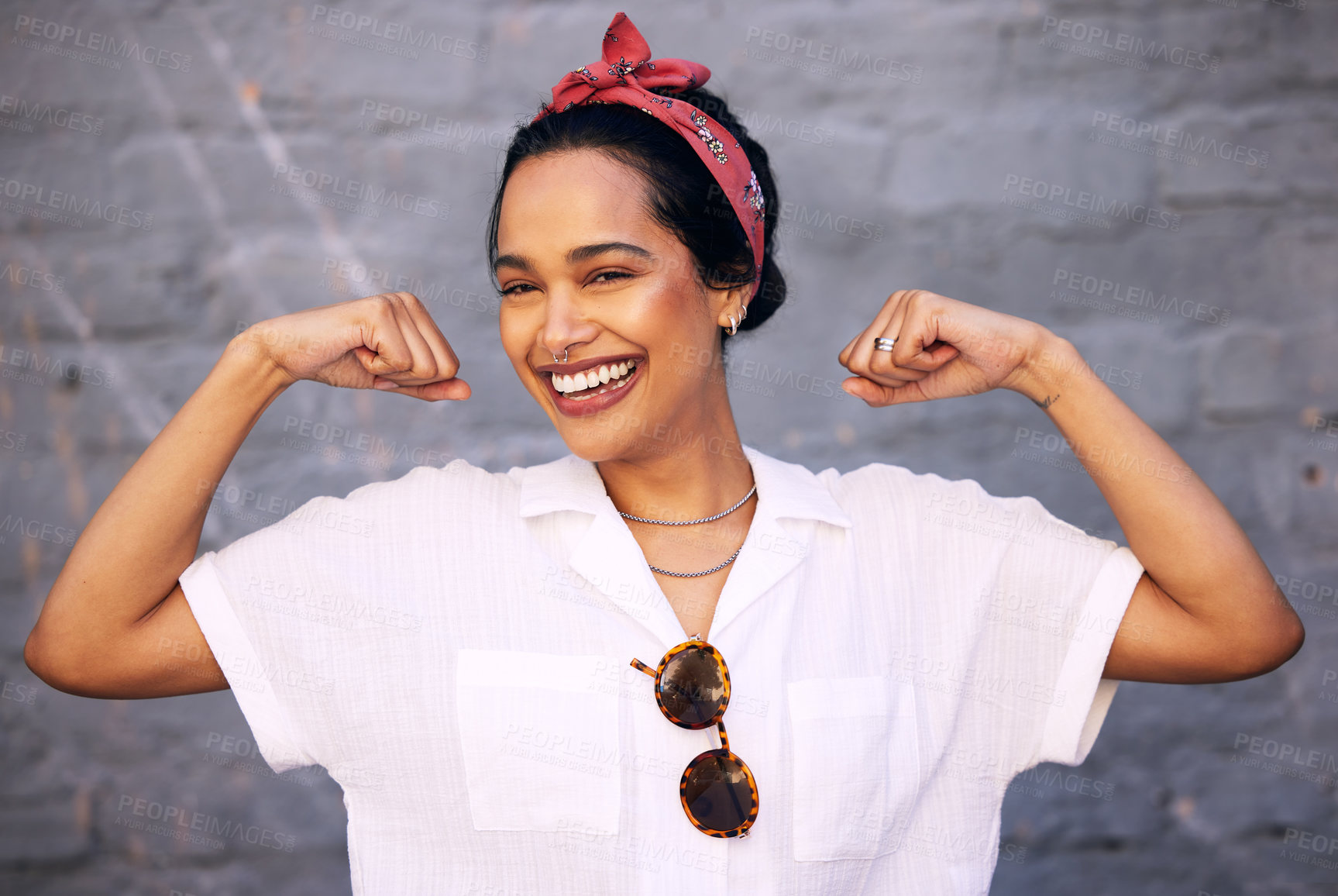 Buy stock photo Arms, fashion and portrait of trendy woman on gray wall background, flexing accessory style. Biceps, model or smile with happy strong gen z person in bandana and chic clothes outfit for casual wear