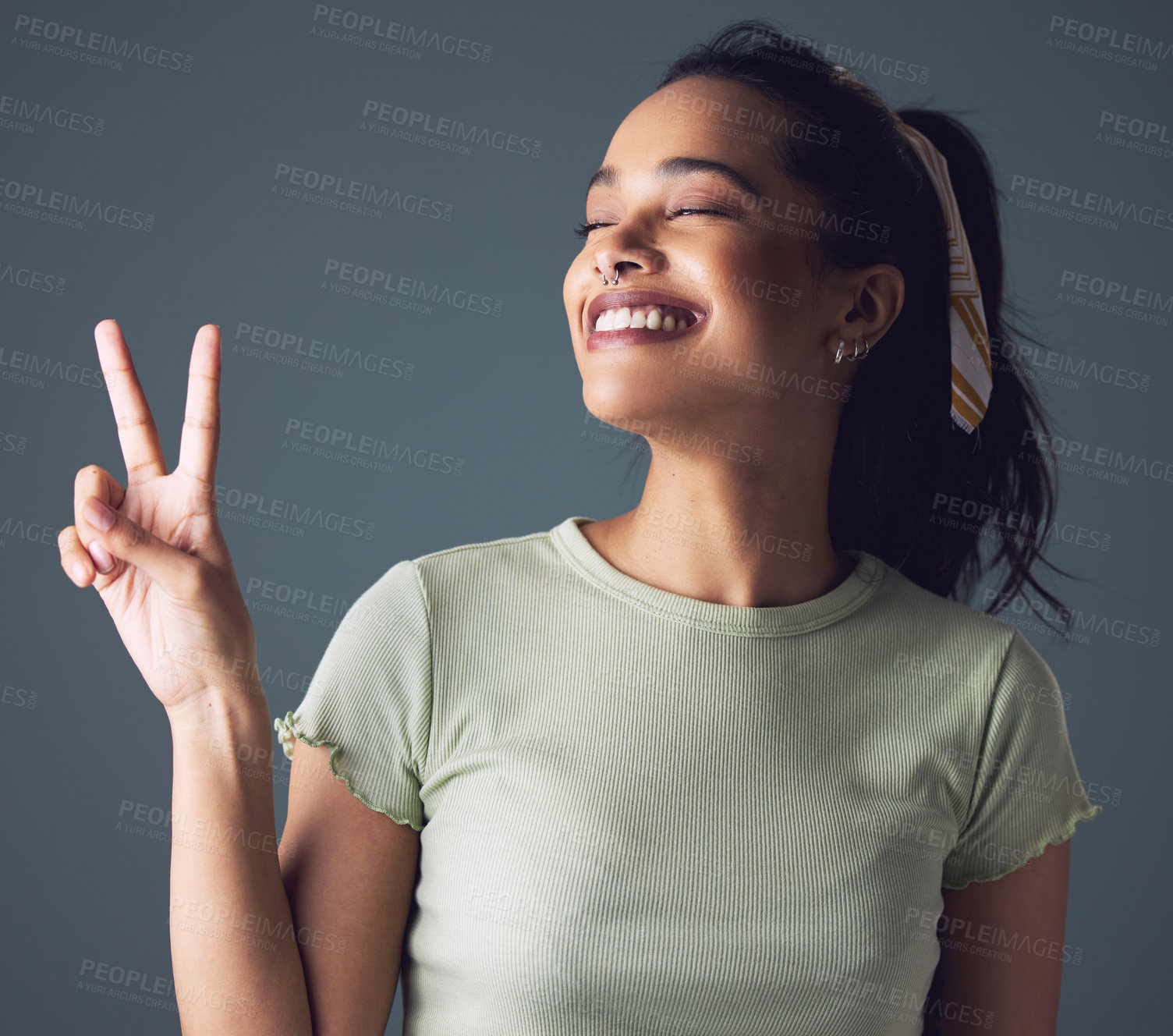 Buy stock photo Woman, smile and hand with peace sign in studio for good mood or emoji, grey background or mockup space. Female person, model and happiness or fingers gesture as v joy for relax, wellness or friendly