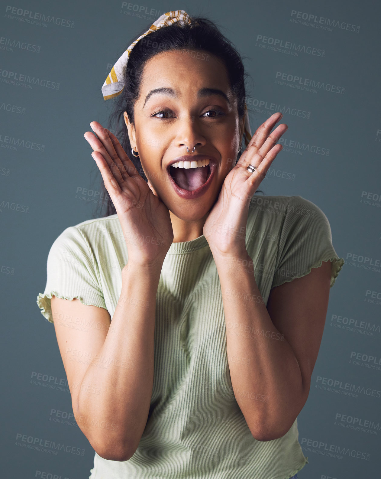 Buy stock photo Happy, surprise and portrait of woman in studio with notification, discount and announcement. Female person, excited emoji and hands on face for information, good news and winning on grey background