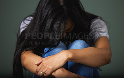 Buy stock photo Cropped shot of an unrecognizable young woman looking depressed against a green background in studio