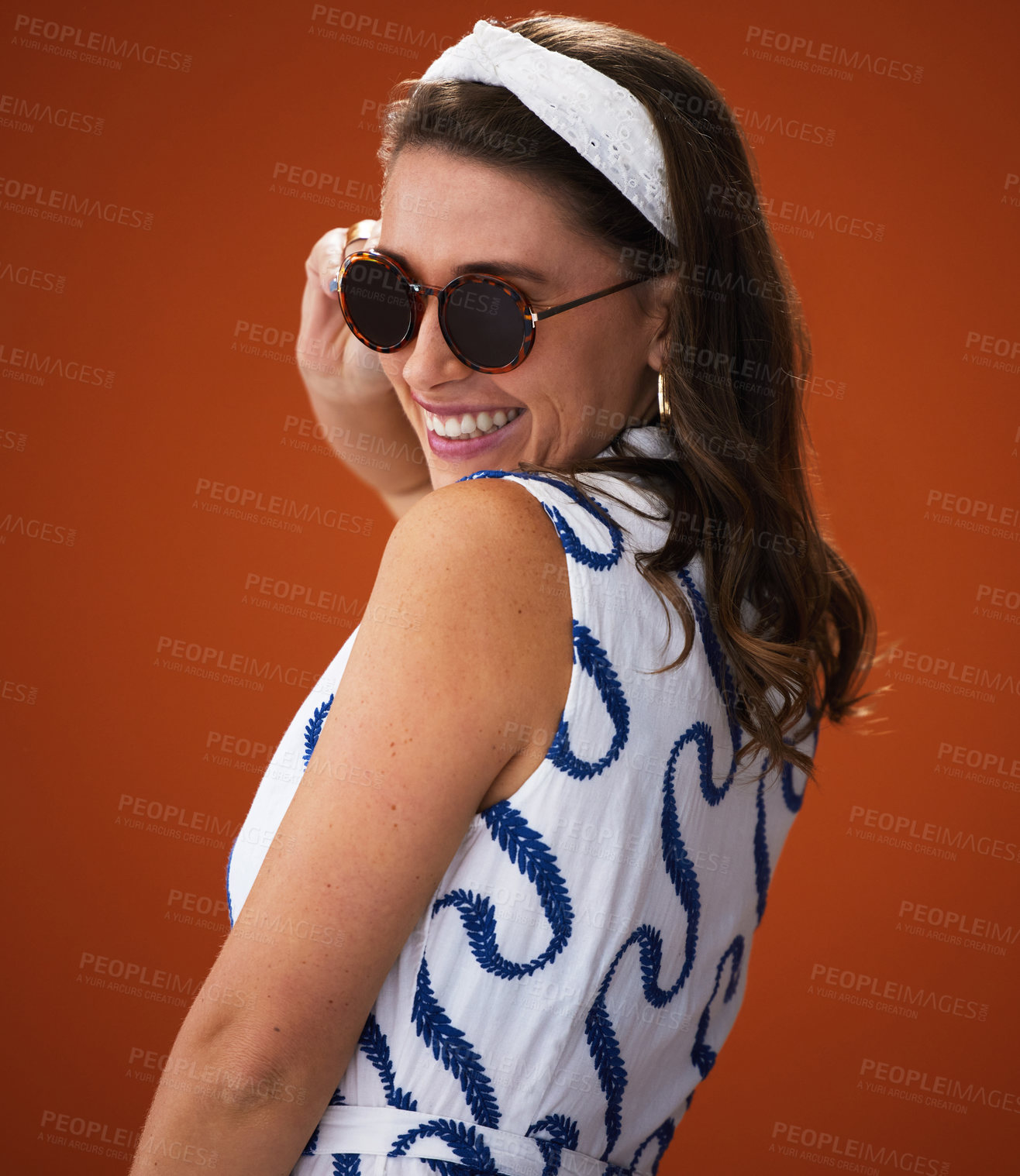 Buy stock photo Studio shot of a stylish young woman posing against a brown background