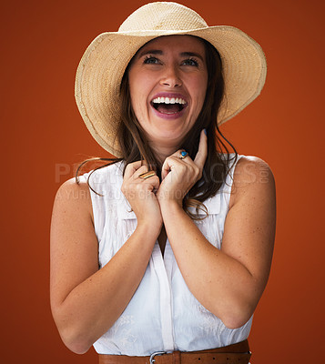 Buy stock photo Woman, hat and studio with laugh for fashion with beauty, trendy and cool outfit for farm girl style inspiration. Happy, background and pretty with expression for casual wear with self esteem