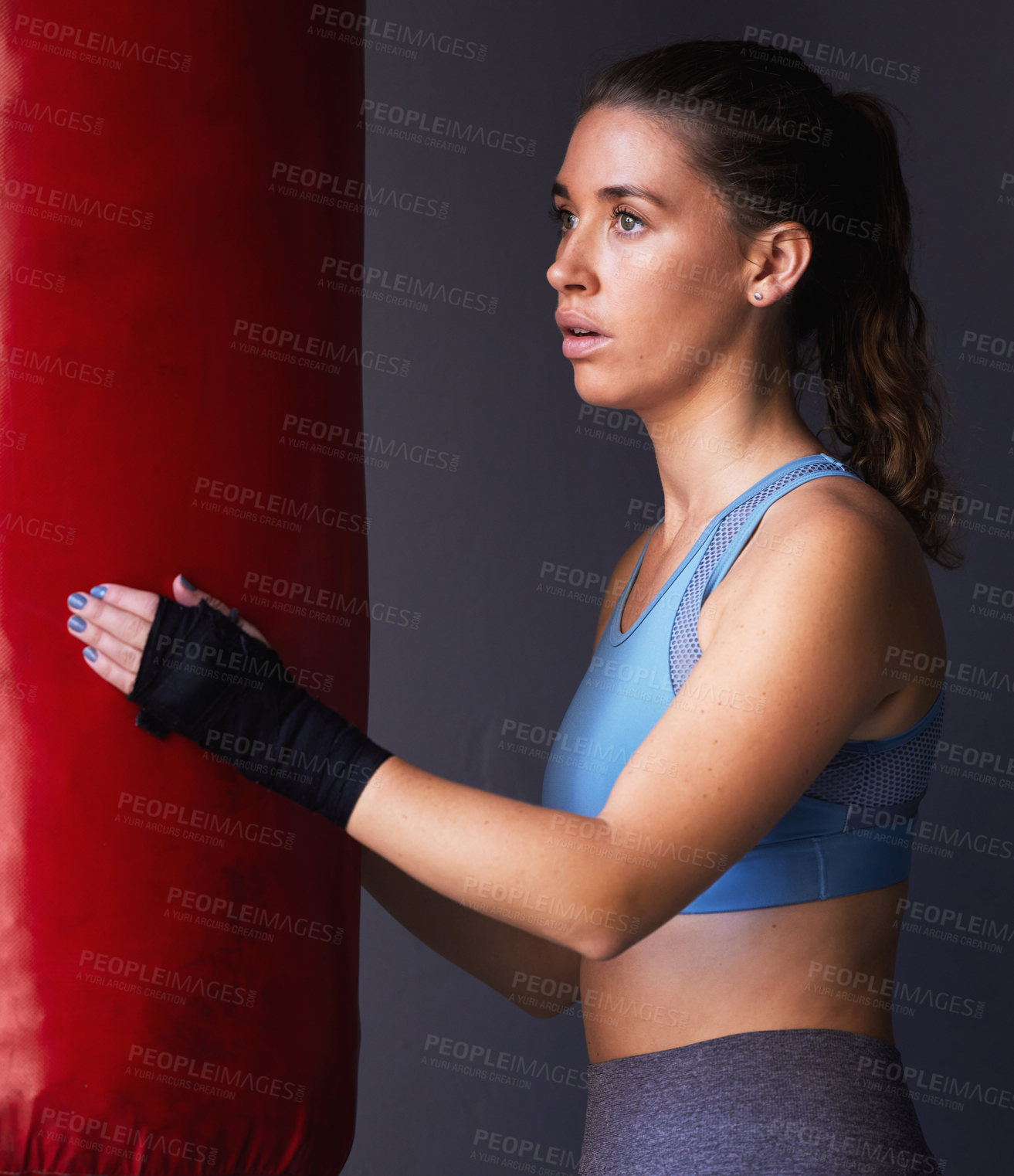 Buy stock photo Sport, boxing bag and woman for fitness in studio as fighter training, exercise and workout in gym for competition. Active, female person and physical activity for health, wellness and self defence