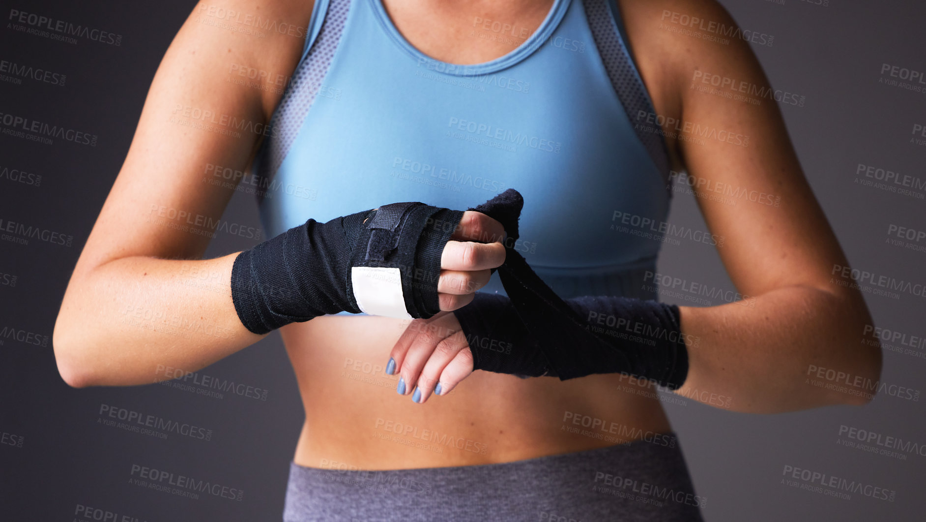 Buy stock photo Boxer, hand and wrapping for fitness, workout and warmup isolated on grey studio background. Woman, exercise and training for health, wellness and body performance for muscle power and cardio