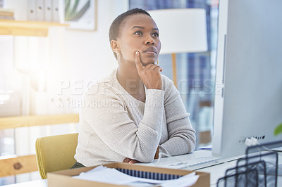 Buy stock photo Shot of a businesswoman looking thoughtful while sitting at her desk