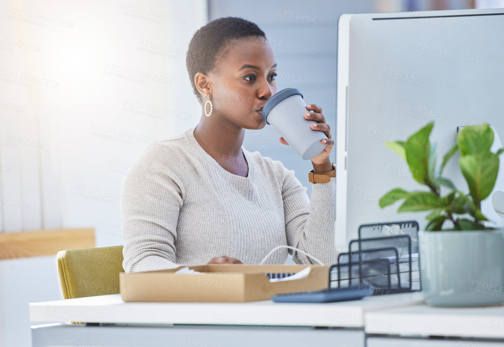 Buy stock photo Shot of a young businesswoman drinking coffee while sitting at her desk