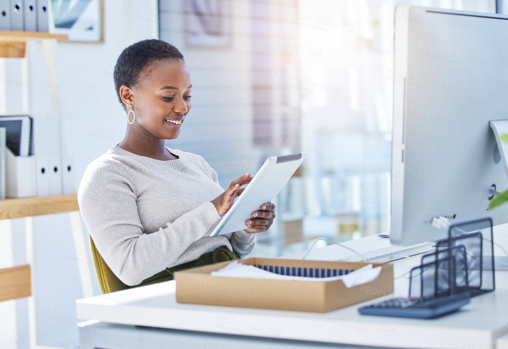 Buy stock photo Tablet, desk and typing and black woman with smile, social media and scrolling for entertainment. Technology, computer and office for creative web designer, distraction and employee on technology