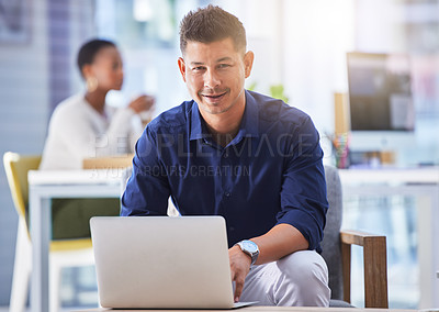 Buy stock photo Shot of a man using a laptop while working in a modern office