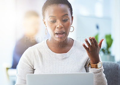 Buy stock photo Shot of a businesswoman talking while using her laptop