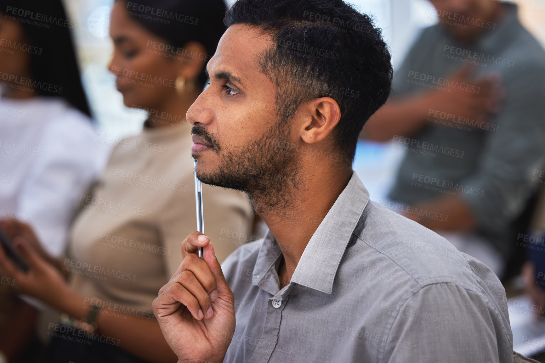 Buy stock photo Shot of a young man thinking during a meeting at work
