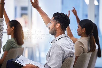 Buy stock photo Shot of a group of people lifting their hands during a work seminar in a modern office