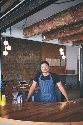 Buy stock photo Shot of a confident young man working in a cafe
