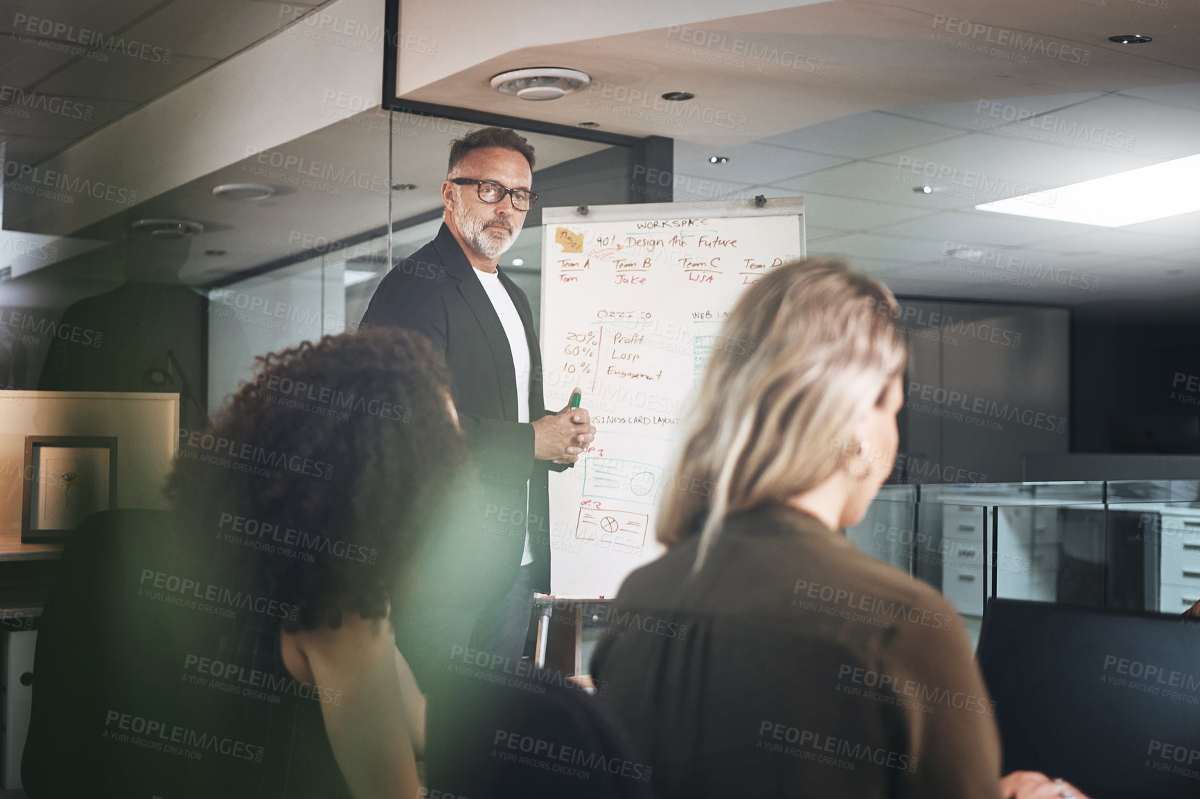 Buy stock photo Shot of a mature businessman delivering a presentation in the boardroom of a modern office