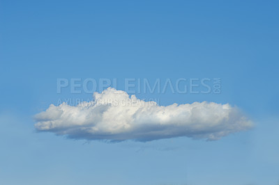 Buy stock photo Copy space with a cloud isolated against a clear blue sky on a sunny day outside. One single fluffy and white cloud floating in a peaceful landscape wallpaper and quiet scene for nature background